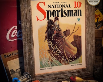May include: A vintage June 1934 issue of National Sportsman magazine featuring a colorful illustration of a fish jumping out of the water. The magazine cover has a price of 10 cents and the text "NRA" is visible in the upper right corner.
