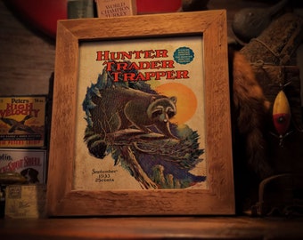 May include: A vintage magazine cover featuring a raccoon on a tree branch. The cover is titled "Hunter Trader Trapper" and the date is September 1933. The magazine costs 25 cents.