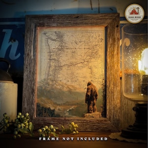 May include: A vintage map of Oregon and Washington Territory with a Bigfoot standing on a mountain peak. The map is framed in a rustic wooden frame. The text "FRAME NOT INCLUDED" is printed below the frame.