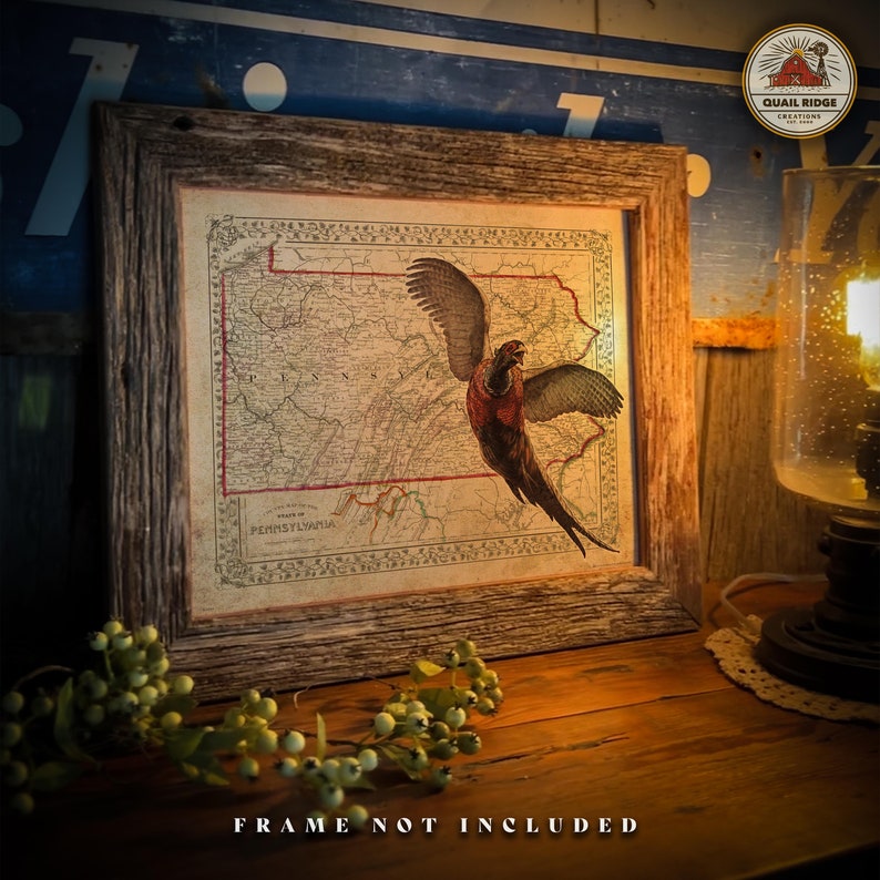 May include: A vintage map of Pennsylvania with a pheasant flying over it. The map is framed in a rustic wooden frame. The image is labeled "Quail Ridge Creations".