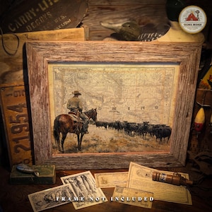 May include: A vintage-style print of a cowboy riding a horse with a herd of cattle in the background. The print is framed in a rustic wooden frame. The print features a map of the state of Minnesota with the word "MINNESOTA" printed on the map.