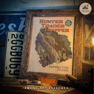 May include: A vintage magazine cover for Hunter Trader Trapper, featuring a raccoon climbing a tree. The cover is dated September 1932 and costs 25 cents. The magazine cover is framed in a rustic wooden frame.