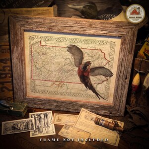 May include: A vintage map of Pennsylvania with a pheasant flying over it. The map is framed in a rustic wooden frame. The frame is not included.