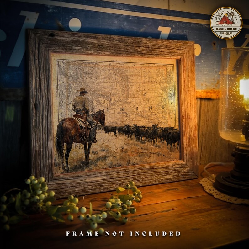 May include: A vintage-style print of a cowboy riding a horse through a field of cattle. The print is framed in a rustic wooden frame. The print features the word "MINNESOTA" in the background.