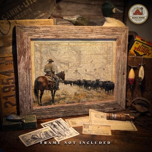May include: A framed vintage map print of the United States with a cowboy riding a horse in the foreground. The map shows the states of Minnesota, Iowa, and Wisconsin. The print is in a rustic wooden frame.