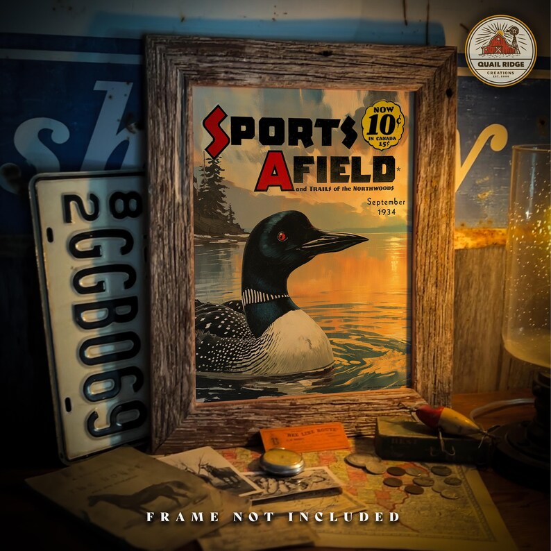May include: A vintage magazine cover featuring a loon swimming in a lake with a sunset in the background. The magazine is titled "Sports Afield" and the date is September 1934. The cover is framed in a rustic wooden frame.