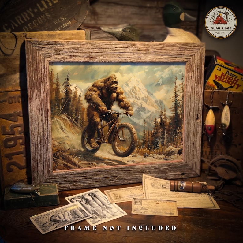 May include: A framed painting of a Bigfoot riding a bicycle through a snowy mountain landscape. The painting is set against a rustic wooden background with various other items, including a duck decoy, fishing lures, and a box of shotgun shells.