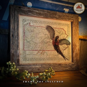 May include: A vintage map of Pennsylvania with a pheasant flying over it. The map is framed in a rustic wooden frame. The frame is not included.