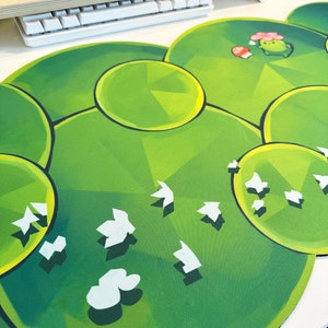 May include: Green and white mousepad with a geometric pattern and a cartoon character with a mushroom and flower.