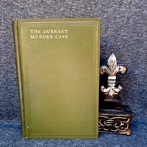 May include: A green hardcover book with the title "The Durrant Murder Case" printed in white on the front cover.