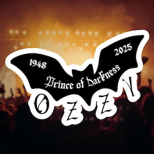 May include: A black bat-shaped sticker with the text "Prince of Darkness" and the name "OZZY". The sticker also includes the years "1948" and "2025". The background shows a concert crowd with stage lights.