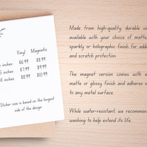 May include: A white spiral-bound notebook with handwritten text detailing vinyl and magnetic sticker sizes: 4, 5, and 6 inches. The text also describes the finishes available, including matte, glossy, sparkly, and holographic.