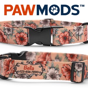 May include: A pink dog collar with a floral pattern featuring red and white flowers. The collar has a black buckle and a black D-ring. The collar is personalized with the name "Bella" and a phone number.