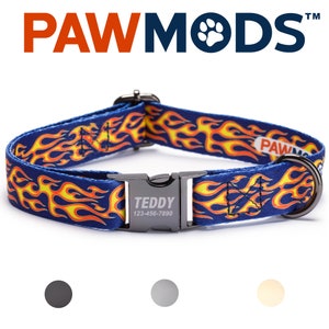 May include: A blue dog collar with a yellow and orange flame pattern. The collar has a black metal buckle with the name "TEDDY" and the phone number "123-456-7890" engraved on it.
