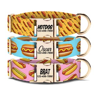 May include: Three dog collars with gold-colored hardware and food-themed patterns. One collar features corn dogs on a yellow background, another has hot dogs on a blue background, and the third has hot dogs on a pink background. Each collar has a buckle with a name and phone number.