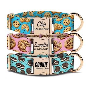 May include: Three dog collars with gold-colored hardware and personalized nameplates. The collars feature colorful patterns: chocolate chip cookies on blue, chocolate chip cookies on pink, and chocolate sandwich cookies on teal. Each nameplate includes a name and phone number.