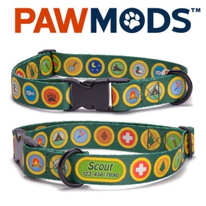 May include: Green dog collar with a Scout theme. The collar features a repeating pattern of yellow and green merit badges with various images, including a compass, tent, first aid cross, and campfire. The collar has a black buckle and a black D-ring. A personalized tag with the text "Scout 123-456-7890" is attached to the collar.