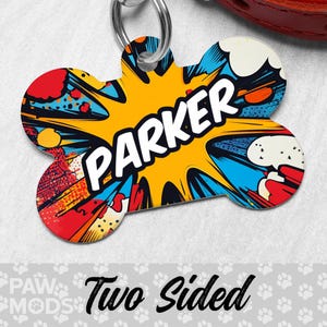 May include: A bone-shaped dog tag with a comic book style design. The tag is yellow, red, blue, and white with the name "Parker" in white letters. The tag is two-sided.