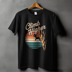 May include: Black t-shirt with a retro-style graphic of a person rock climbing with the text "Climb Higher".