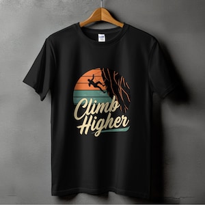 May include: Black t-shirt with a vintage-style graphic of a person rock climbing with the text "Climb Higher".