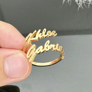 May include: Gold ring with the names "Chloe" and "Gabrielle" written in cursive.
