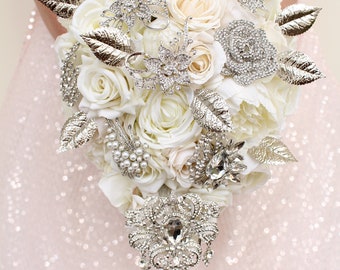 White wedding bouquet. Silver brooch bouquet. Cascade bridal bouquet. Jeweled bouquet by Weddiology