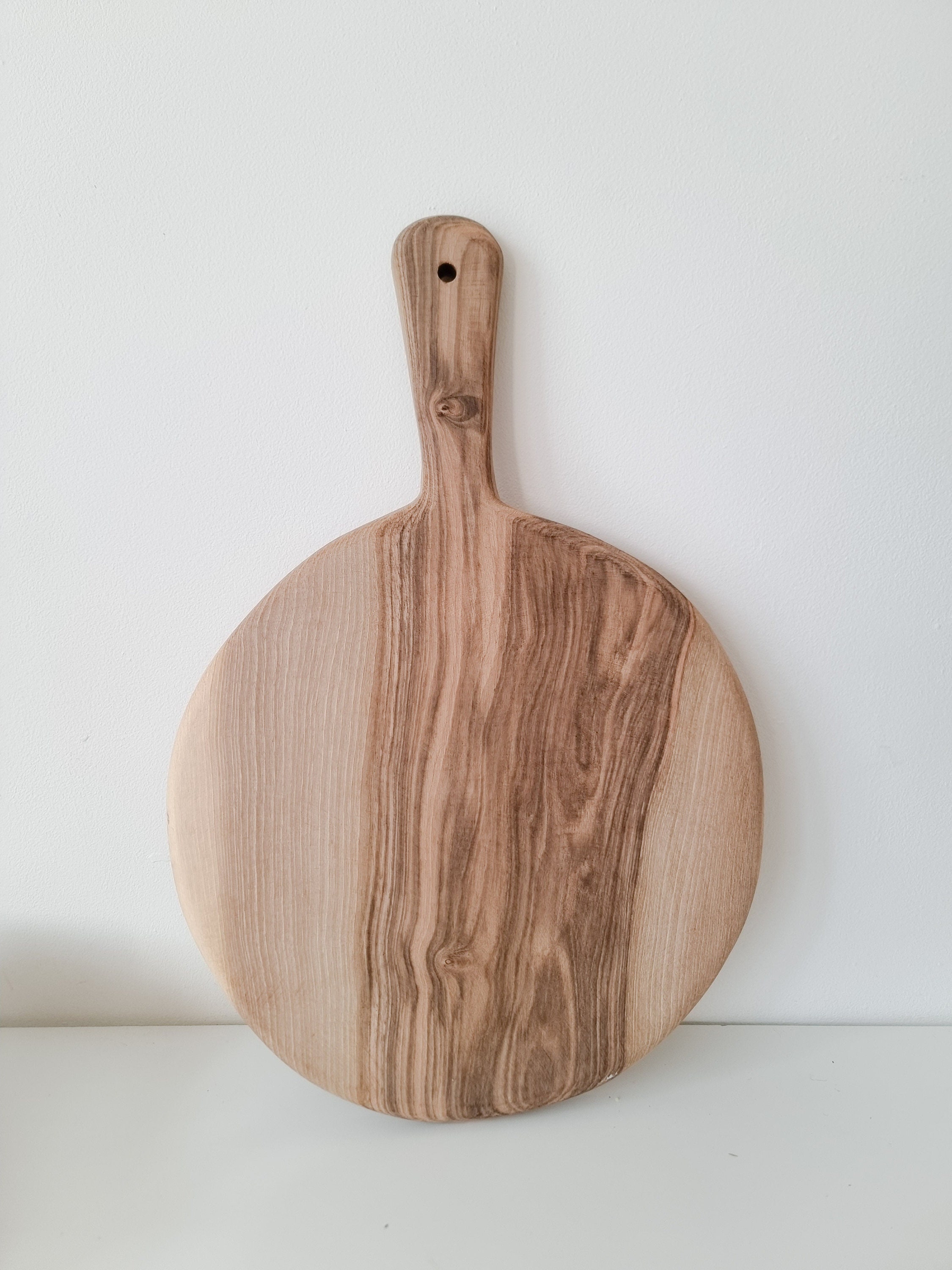 Round walnut wood cutting board