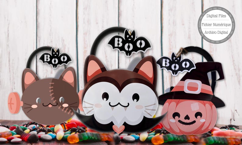 May include: Three Halloween-themed treat buckets. One is a brown cat with stitches, another is a vampire cat, and the last is a pumpkin wearing a witch hat. Each bucket has a black handle and a bat with the word "BOO" on it.