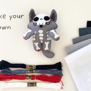 Halloween-themed skeleton wolf plush made from a felt sewing pattern, displayed with sewing felt materials.