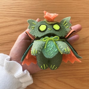 Stuffed halloween cat plush toy, handcrafted from felt, ideal for gothic, witchy, or spooky home decor. Close-up of a soft swamp cat plush using a beginner-friendly PDF pattern, with cute embroidered details.