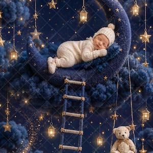 May include: A sleeping infant in a cream-colored knit outfit and matching hat rests on a large, dark blue crescent moon prop. A rope ladder hangs from the moon, and a small teddy bear sits on a swing below, surrounded by hanging lanterns and stars.