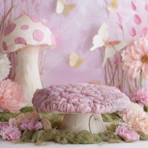 May include: A whimsical photography prop featuring a pink mushroom-shaped platform with a textured top, surrounded by flowers and butterflies. The backdrop is a soft pink with floral accents, creating a fairytale scene.