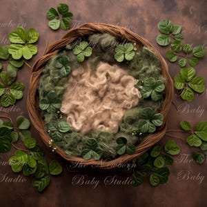 May include: A brown wicker basket filled with green moss and faux shamrock leaves, with a fluffy white prop for newborn photography.