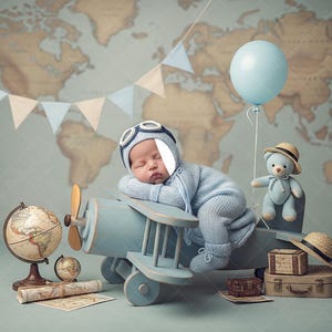 May include: A sleeping baby in a blue aviator outfit rests on a light blue toy airplane. A teddy bear with a hat, a globe, and a world map backdrop complete the travel-themed scene. A blue balloon floats nearby.