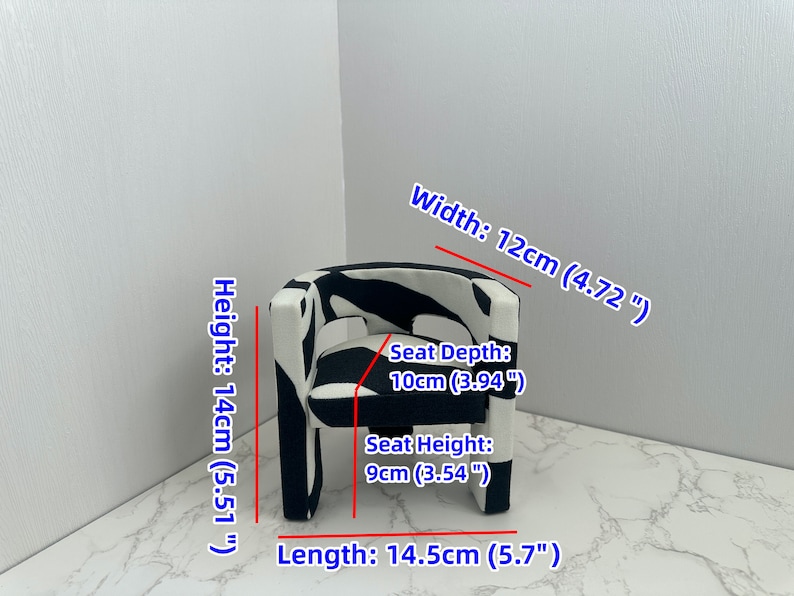 May include: A small black and white patterned armchair with a seat depth of 10cm (3.94 inches), a seat height of 9cm (3.54 inches), a width of 12cm (4.72 inches), a length of 14.5cm (5.7 inches), and a height of 14cm (5.51 inches).
