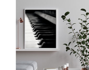 May include: A black and white photograph of a piano keyboard. The keys are in focus, and the background is blurred.