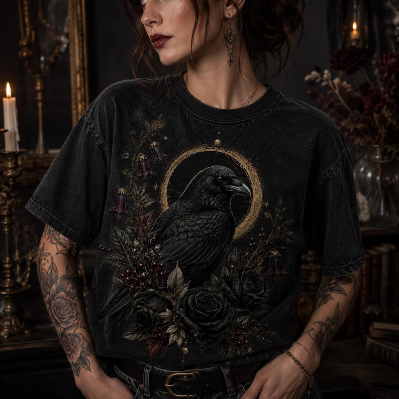 Lifestyle mockup showing a woman wearing a washed black T-shirt printed with the gothic raven and black rose design.
