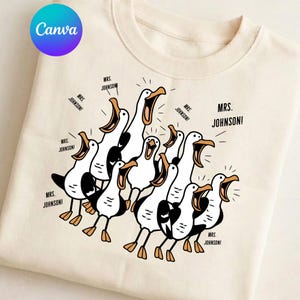 May include: A cream-colored crewneck sweatshirt featuring a graphic print of multiple white and black seagulls with orange beaks and feet. Each bird is depicted with an open beak, and the text "MRS. JOHNSON!" is repeated throughout the design.