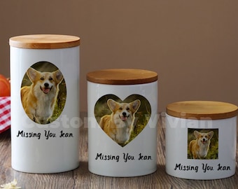 May include: Three white ceramic jars with wooden lids, each featuring a different photo of a corgi dog. The jars have the text "Missing You Jean" printed on them.