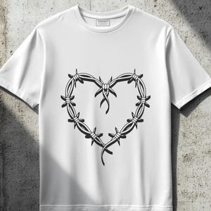 May include: White t-shirt with a black barbed wire heart design.