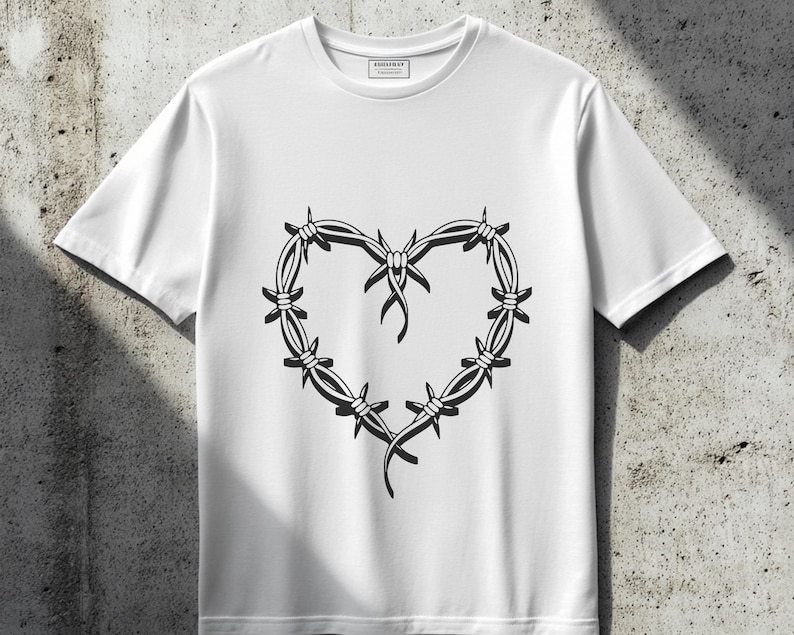 May include: White t-shirt with a black barbed wire heart design.