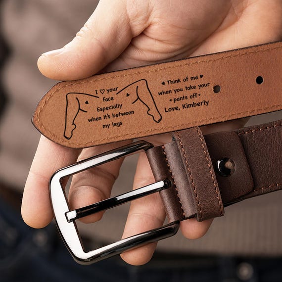 A real leather belt laser-engraved with a custom funny/romantic message — wearable personalization that hides a joke or love note on the inside.