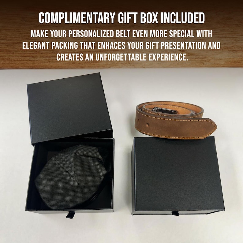 May include: A tan leather belt coiled next to a black gift box. The box is open, revealing a black fabric pouch inside. Text at the top reads: COMPLIMENTARY GIFT BOX INCLUDED. MAKE YOUR PERSONALIZED BELT EVEN MORE SPECIAL WITH ELEGANT PACKING.