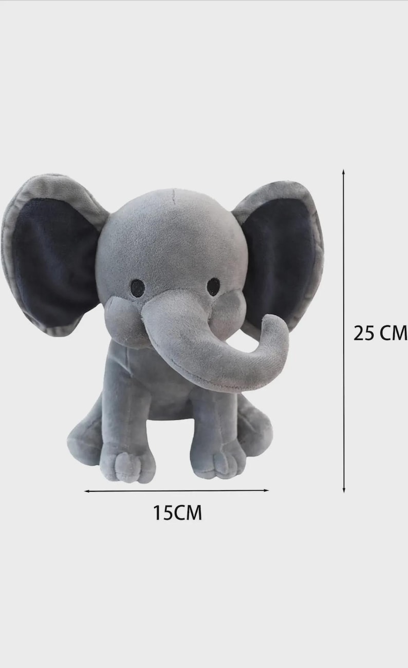 May include: A gray plush elephant toy with large ears, dark eyes, and a curved trunk. The toy is shown with dimension lines indicating a height of 25 cm and a width of 15 cm, which is approximately 9.84 inches in height and 5.91 inches in width.