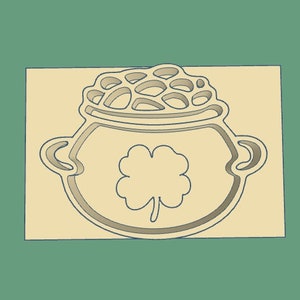 May include: A brown pot with a gold clover design and a gold lid with a cutout design. The pot is a traditional Irish symbol of good luck.