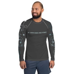May include: A dark gray long-sleeve shirt with a geometric pattern in shades of blue and white. The shirt has the text "Φ UNIPHI MMA AND FITNESS" printed on the front.