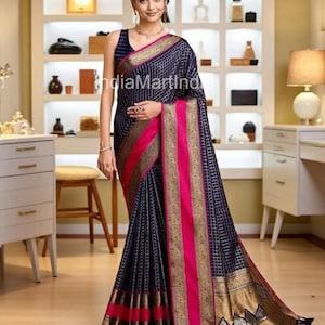 May include: A navy blue saree with a grid pattern, accented with vibrant pink and gold borders. The saree features intricate detailing and a flowing design, showcasing traditional Indian textile artistry. The image displays a woman wearing the saree.
