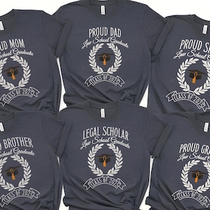 May include: Six navy blue t-shirts with white text and graphics. The shirts say "Proud Mom", "Proud Brother", "Proud Dad", "Proud Sister", "Legal Scholar", and "Proud Grandpa". Each shirt has a graduation cap and laurel wreath graphic and the text "Law School Graduate" and "Class of 2025".