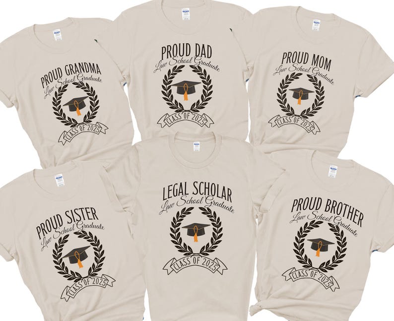 May include: Six beige t-shirts with black text and graphics. The shirts say "Proud Grandma", "Proud Dad", "Proud Mom", "Legal Scholar", "Proud Sister", and "Proud Brother". Each shirt has a laurel wreath with a graduation cap and the text "Law School Graduate" and "Class of 2025".