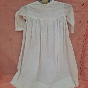 Child&#39;s cotton dress with blue wooden hanger
